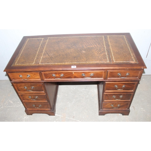 146 - A vintage leather topped pedestal desk with 9 drawers and brass handles, approx 123cm wide x 61cm de... 