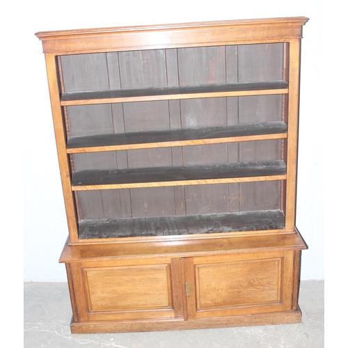 152 - Vintage wooden bookshelf with adjustable shelves and 2 door cupboard base, approx 121cm wide x 28cm ... 