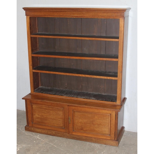 152 - Vintage wooden bookshelf with adjustable shelves and 2 door cupboard base, approx 121cm wide x 28cm ... 