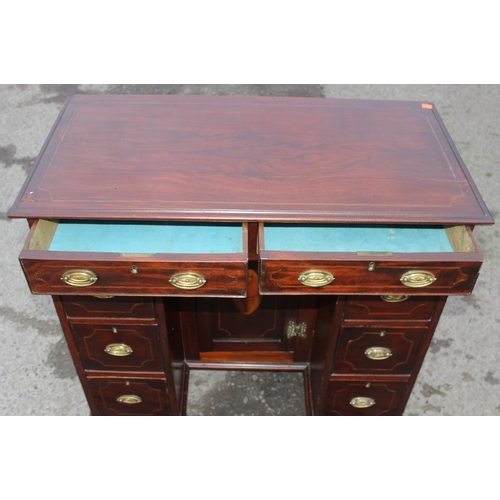 33 - A 19th century mahogany and Sheraton style satinwood inlaid kneehole desk with 8 drawers and a cupbo... 