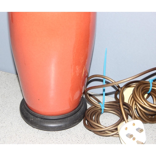 249 - Pair of Chinese style shaped pottery lamps on wooden base, in a orange/red terracotta colour, approx... 