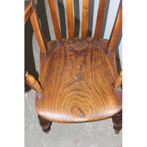 143 - A 19th century farmhouse slatback Windsor armchair with elm seat, approx 56cm wide x 65cm deep x 110... 