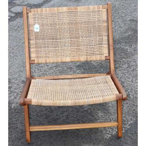 9 - A retro Scandinavian style wooden and rattan lounge chair, approx 65cm wide x 80cm deep x 70cm tall