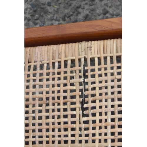 9 - A retro Scandinavian style wooden and rattan lounge chair, approx 65cm wide x 80cm deep x 70cm tall