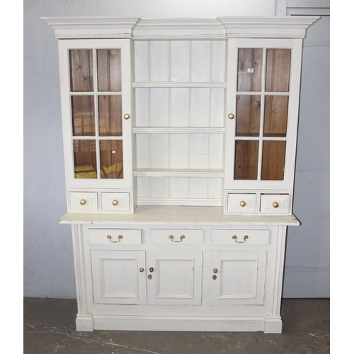 13 - A large vintage painted pine dresser, the base with 3 drawers over 3 cupboards and the top with 2 gl... 