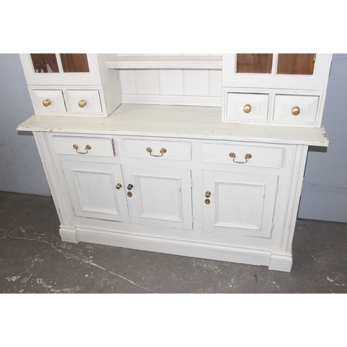 13 - A large vintage painted pine dresser, the base with 3 drawers over 3 cupboards and the top with 2 gl... 