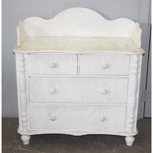 14 - A distressed white painted pine 2 over 2 chest of drawers with bun handles, approx 112cm wide x 57cm... 