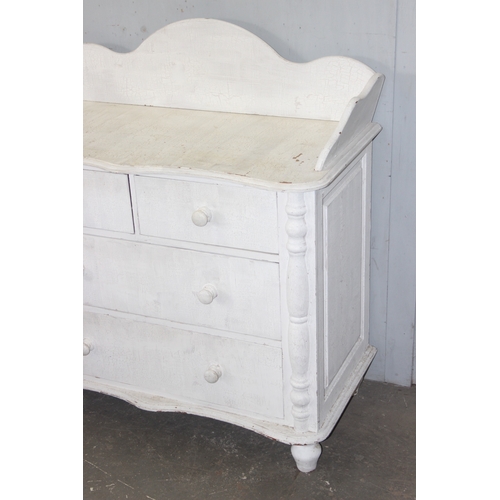 14 - A distressed white painted pine 2 over 2 chest of drawers with bun handles, approx 112cm wide x 57cm... 