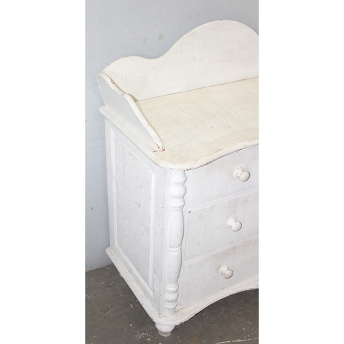 14 - A distressed white painted pine 2 over 2 chest of drawers with bun handles, approx 112cm wide x 57cm... 