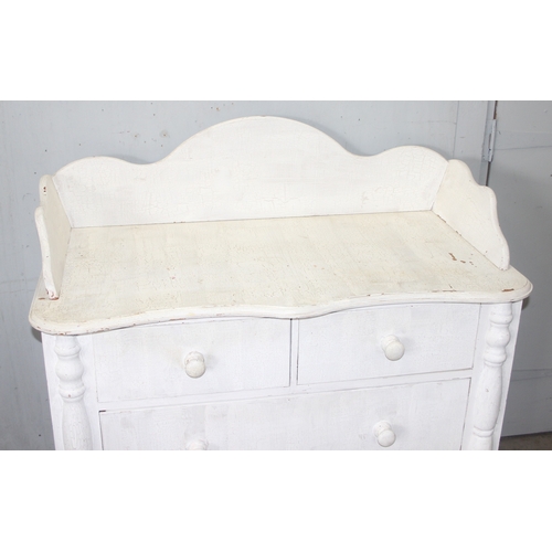 14 - A distressed white painted pine 2 over 2 chest of drawers with bun handles, approx 112cm wide x 57cm... 