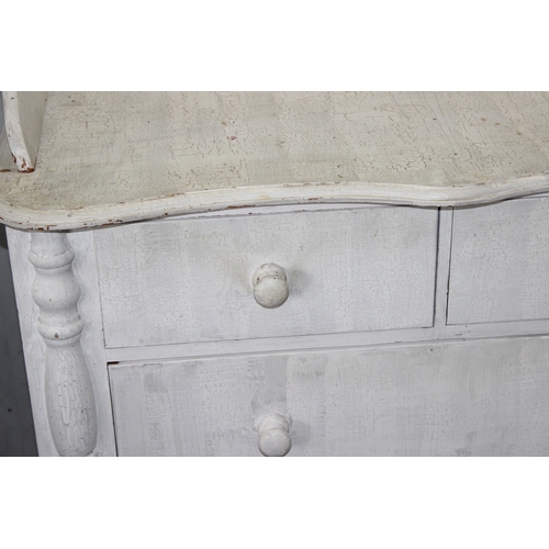 14 - A distressed white painted pine 2 over 2 chest of drawers with bun handles, approx 112cm wide x 57cm... 