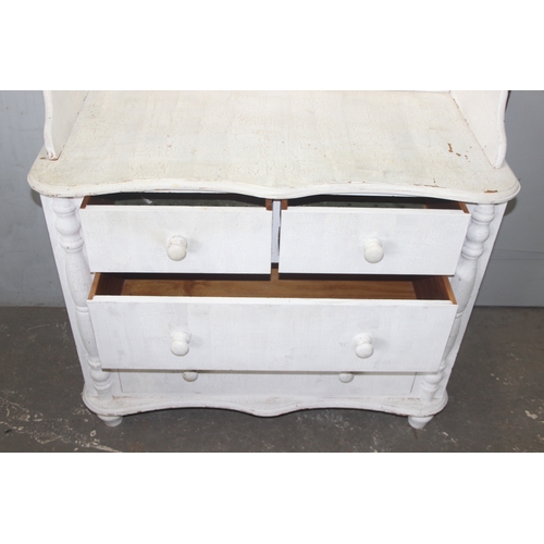 14 - A distressed white painted pine 2 over 2 chest of drawers with bun handles, approx 112cm wide x 57cm... 