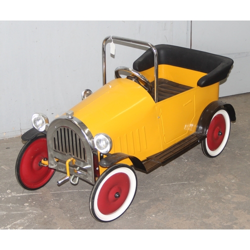 1500 - A vintage style metal child's pedal car, approx 110cm long, yellow painted like Brum