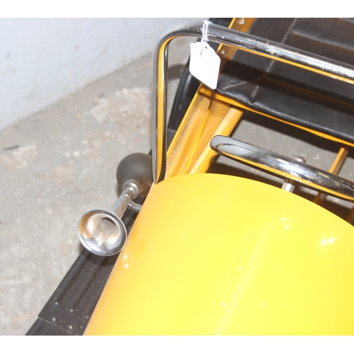 1500 - A vintage style metal child's pedal car, approx 110cm long, yellow painted like Brum