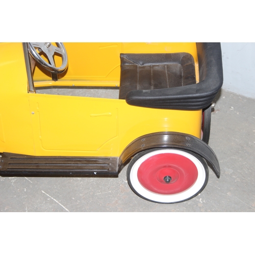 1500 - A vintage style metal child's pedal car, approx 110cm long, yellow painted like Brum