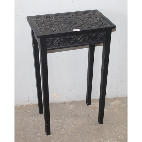 16 - A small vintage black painted oak side table with carved top, approx 49cm wide x 30cm deep x 78cm ta... 