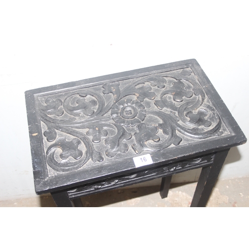 16 - A small vintage black painted oak side table with carved top, approx 49cm wide x 30cm deep x 78cm ta... 