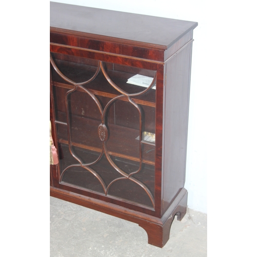 21 - An antique style glazed mahogany bookcase, approx 122cm wide x 32cm deep x 100cm tall