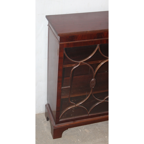 21 - An antique style glazed mahogany bookcase, approx 122cm wide x 32cm deep x 100cm tall