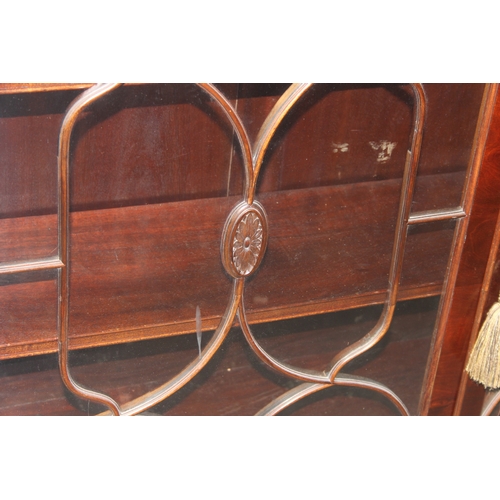 21 - An antique style glazed mahogany bookcase, approx 122cm wide x 32cm deep x 100cm tall