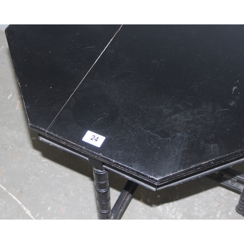 24 - A black painted octagonal side table, approx 67cm wide x 67cm tall