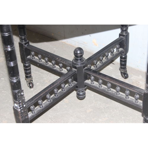 24 - A black painted octagonal side table, approx 67cm wide x 67cm tall