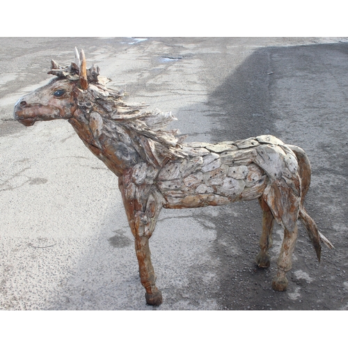 300 - In the manner of Heather Jansch (British 1948-2021), a near life size wooden garden sculpture or fig... 