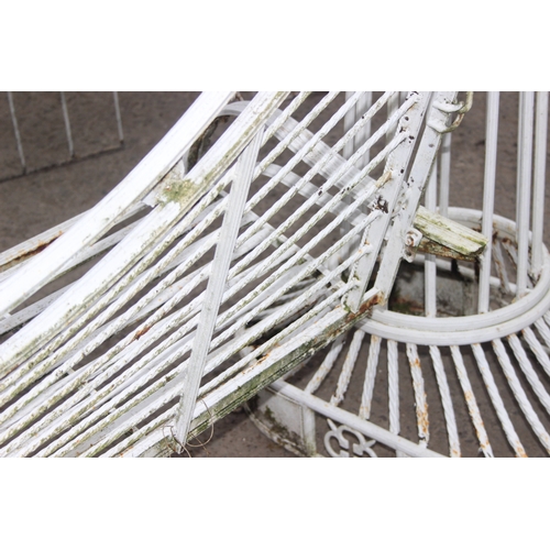 302 - An impressive wrought iron and white painted swing garden seat or bench with planted pillars, approx... 