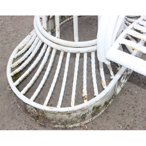 302 - An impressive wrought iron and white painted swing garden seat or bench with planted pillars, approx... 