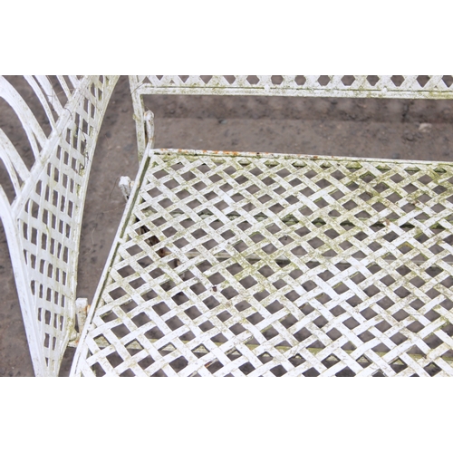 303 - A vintage white painted French style iron garden bench, approx 140cm wide x 105cm tall