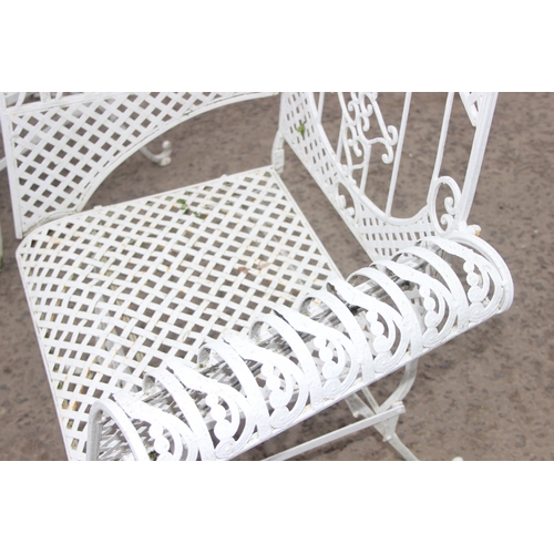 304 - A pair of vintage white painted French style iron garden chairs, each approx 80cm wide x 104cm tall