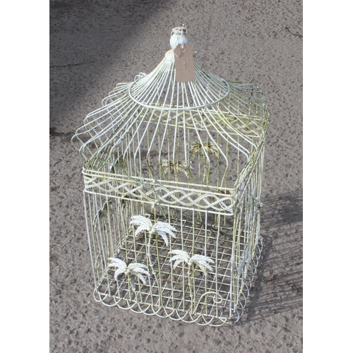 314 - A vintage white painted metal bird cage with palm tree decoration, approx 35cm wide x 35cm deep x 62... 