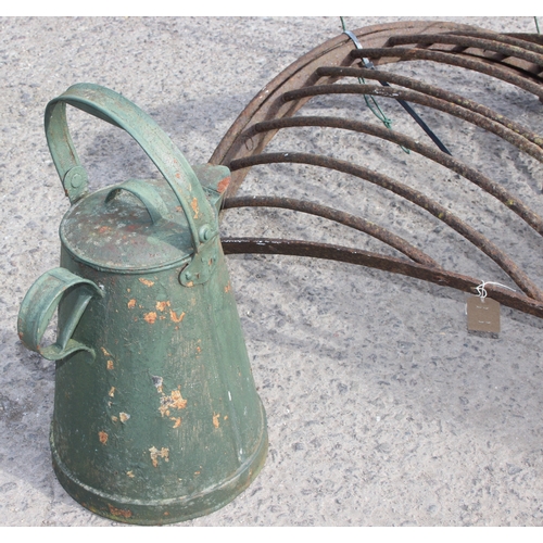 322 - A large vintage painted Kettle, cast iron hay feeder and a wrought iron miniature rocking chair, the... 