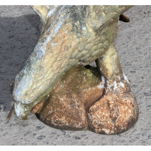 331 - A life size weathered cast iron model of an eagle on rocky base, 20th century, approx 61cm wide x 53... 