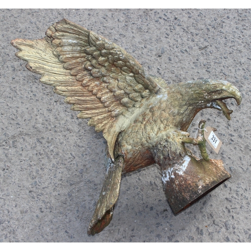 331 - A life size weathered cast iron model of an eagle on rocky base, 20th century, approx 61cm wide x 53... 