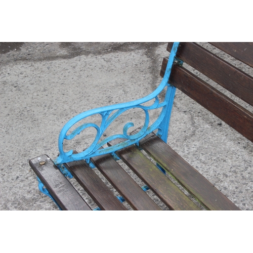 343 - A wooden slatted garden bench with blue painted cast iron ends, approx 123cm wide