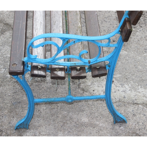 343 - A wooden slatted garden bench with blue painted cast iron ends, approx 123cm wide