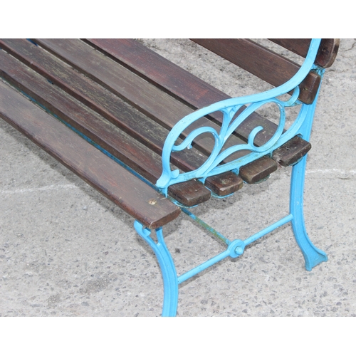 344 - A wooden slatted garden bench with blue painted cast iron ends, approx 113cm wide