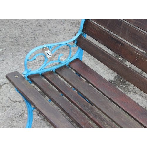 344 - A wooden slatted garden bench with blue painted cast iron ends, approx 113cm wide