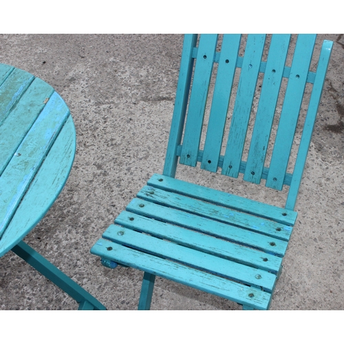 345 - A blue painted wooden Bistro table and 2 chairs, approx 70cm wide x 70cm deep x 74cm tall