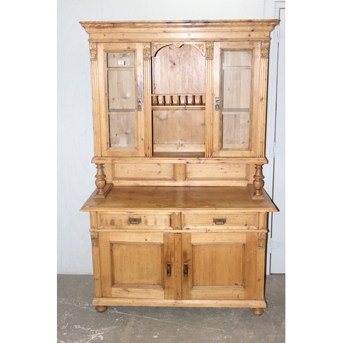 38 - A large Continental antique pine dresser, 2 drawers over 2 cupboards to base with 2 drawer glazed to... 