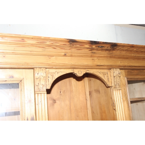 38 - A large Continental antique pine dresser, 2 drawers over 2 cupboards to base with 2 drawer glazed to... 