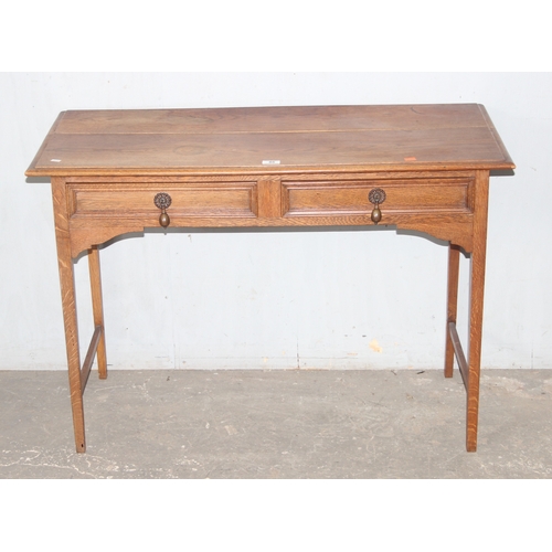 46 - An early 20th century oak side table with 2 drawers, approx 106cm wide x 47cm deep x 72cm tall