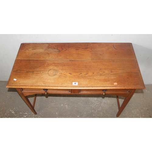 46 - An early 20th century oak side table with 2 drawers, approx 106cm wide x 47cm deep x 72cm tall