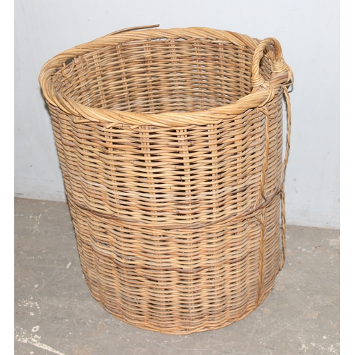 56 - A large vintage wicker log basket, approx 58cm x 58cm excluding handle