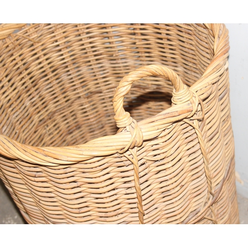 56 - A large vintage wicker log basket, approx 58cm x 58cm excluding handle