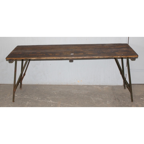 100 - A vintage wooden topped folding trestle table with metal base likely c.1930, approx 181cm wide x 68c... 