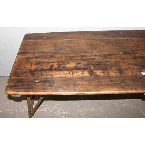 100 - A vintage wooden topped folding trestle table with metal base likely c.1930, approx 181cm wide x 68c... 