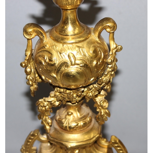 1321 - A highly decorative French brass clock garniture, a highly decorative Rococo style clock flanked by ... 