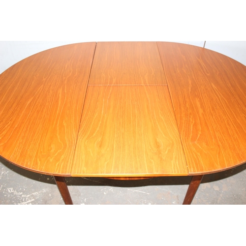 7 - A.H. McIntosh of Kirkcaldy, a retro extending dining table, approx 115cm wide x 115cm deep x 76cm ta... 